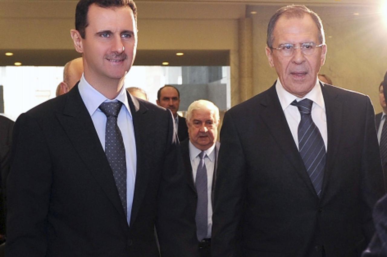 'Syria\'s President Bashar al-Assad (L) welcomes Russian Foreign Minister Sergei Lavrov in Damascus, February 7, 2012, in this handout photograph released by Syria\'s national news agency SANA. Lavrov