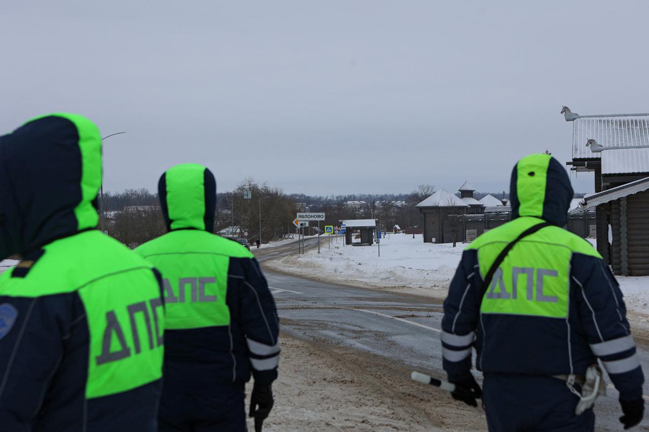 Traffic police officers block off a road near the crash site of the Russian Ilyushin Il-76 military transport plane in Belgorod Region