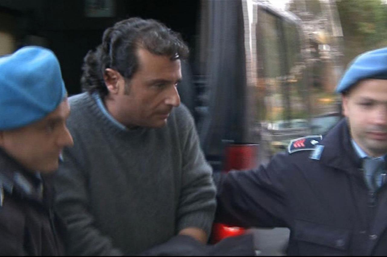'Captain Francesco Schettino (C) of cruise ship Costa Concordia is escorted into a prison by police officers at Grosseto, after being questioned by magistrates in this still image from a video January