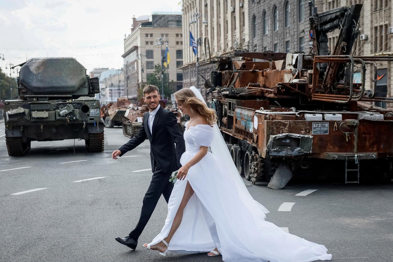 Newlyweds visit an exhibition displaying destroyed Russian military vehicles in central Kyiv