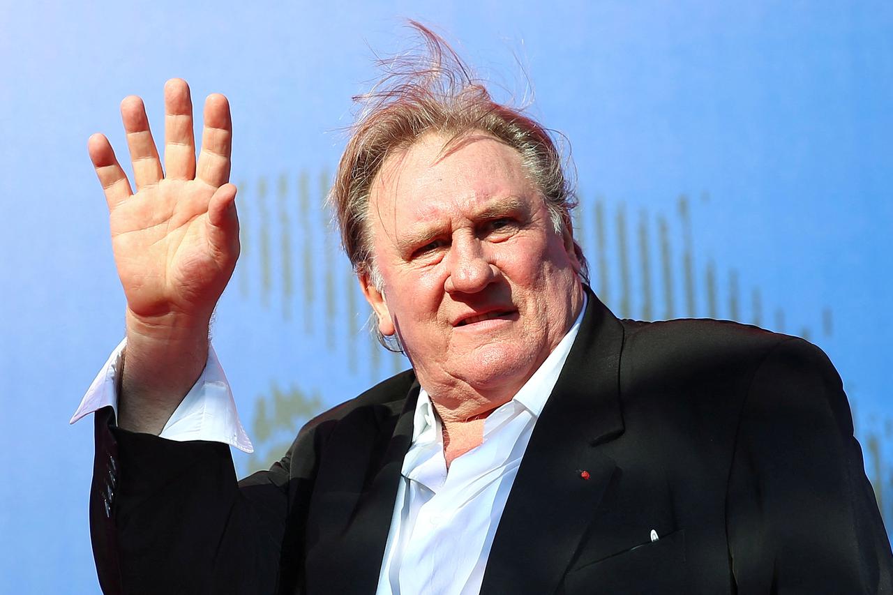 FILE PHOTO: Gerard Depardieu waves as he arrives during a red carpet event for the movie "Novecento- Atto Primo" at the 74th Venice Film Festival in Venice