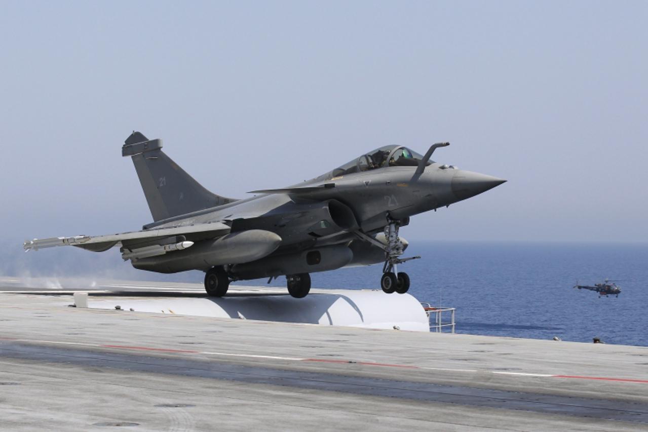 'A Rafale fighter jet makes a catapult launch on the flight deck, where in two seconds the jet goes from 0 to 250 kms per hour, aboard France\'s flagship Charles de Gaulle aircraft carrier March 28, 2