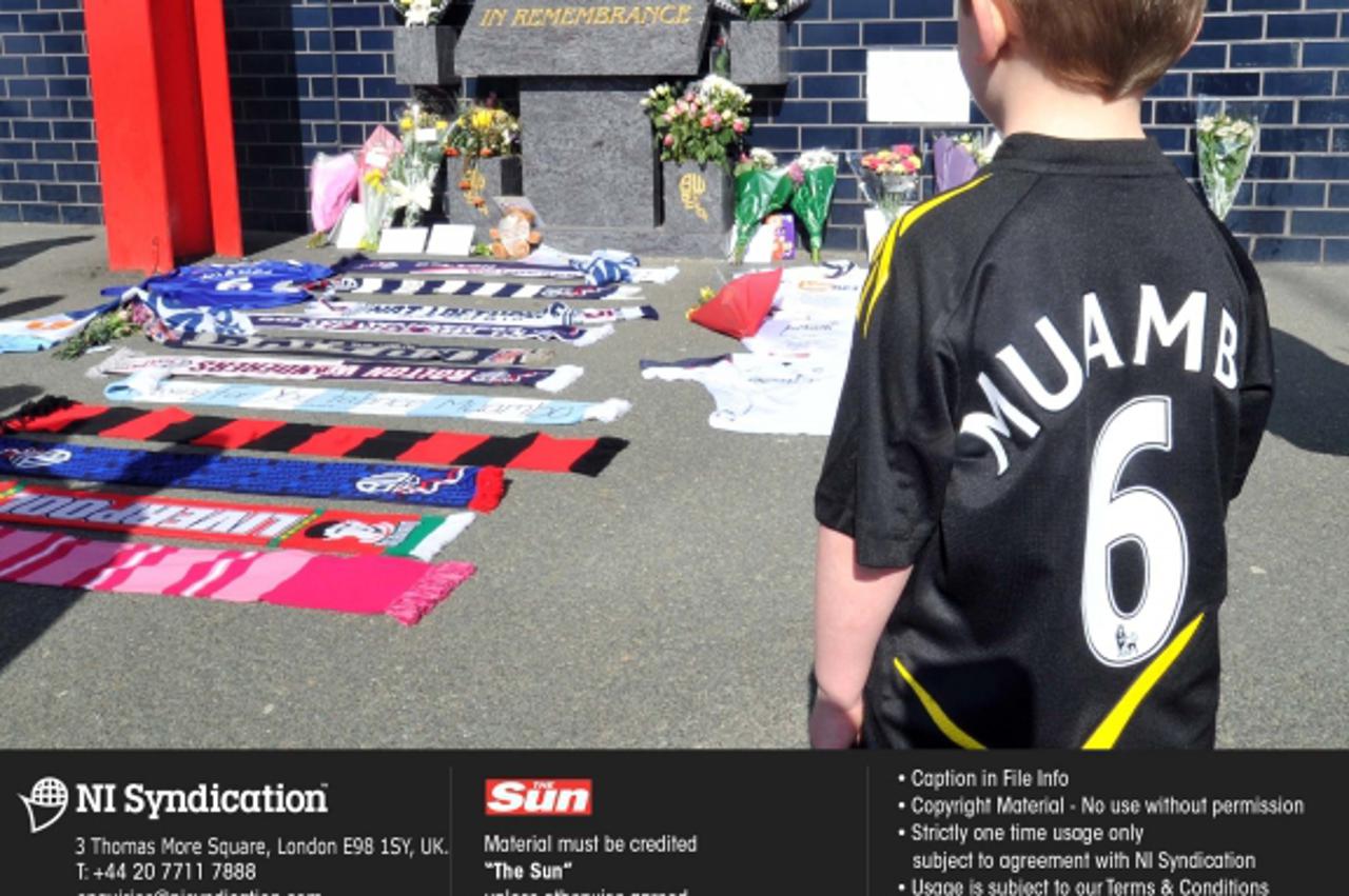 'Card and flowers left for Fabrice Muamba at Bolton\'s football ground after the player collapsed in their FA cup game against Tottenham Hotspur. The player is currently in intensive care. Credit: The