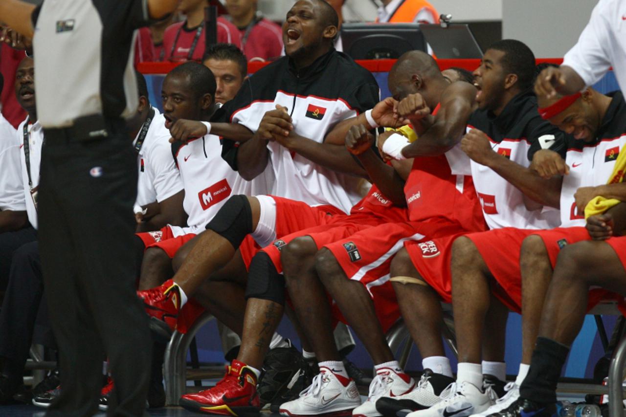 'Angolan players celebrate their victory over Germany during the preliminary round match between Angola and Germany at the FIBA World Basketball Championships at Kadir Has arena in Kayseri on Septemer