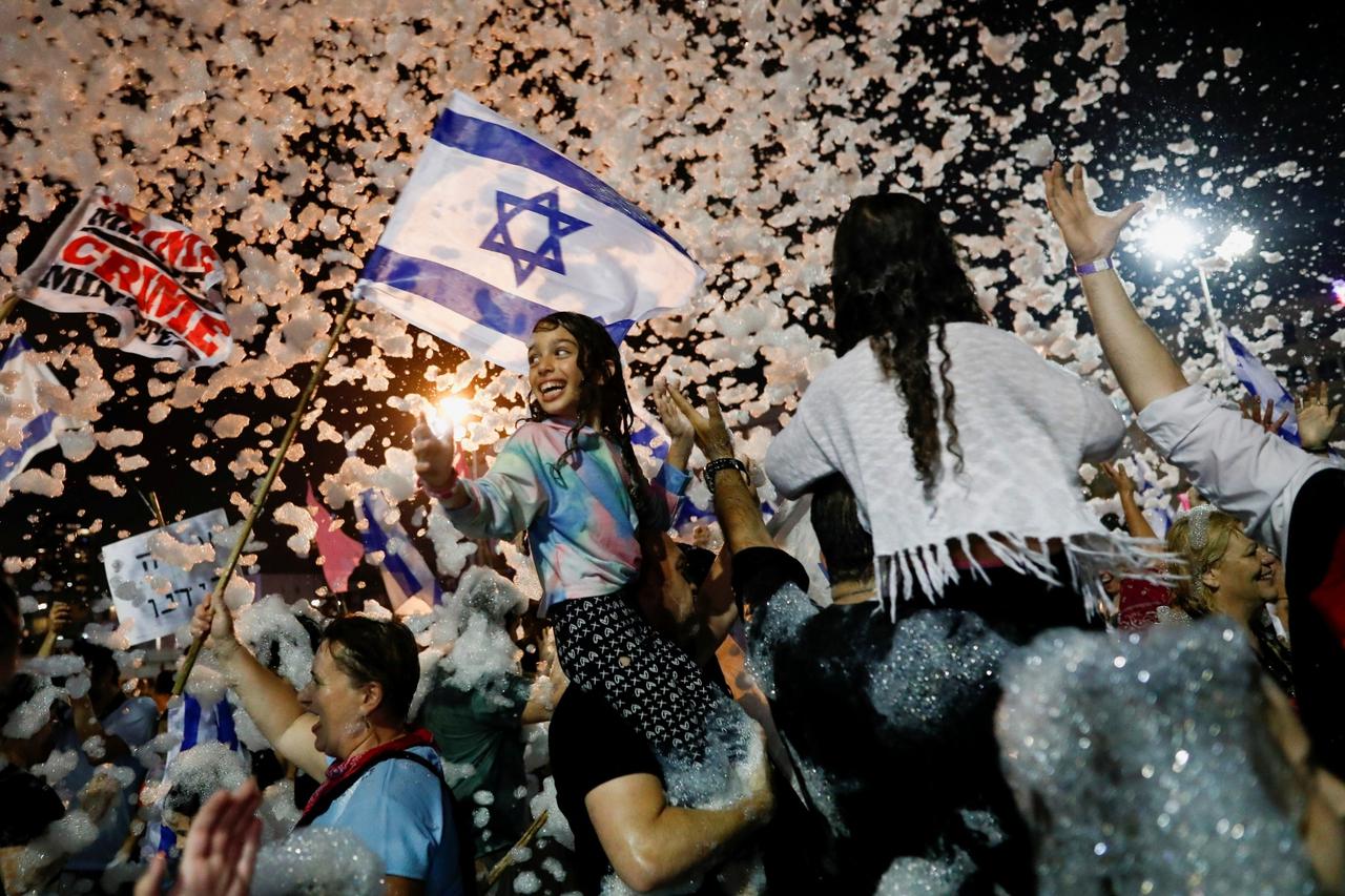 Supporters of the new Israeli government celebrate in Tel Aviv