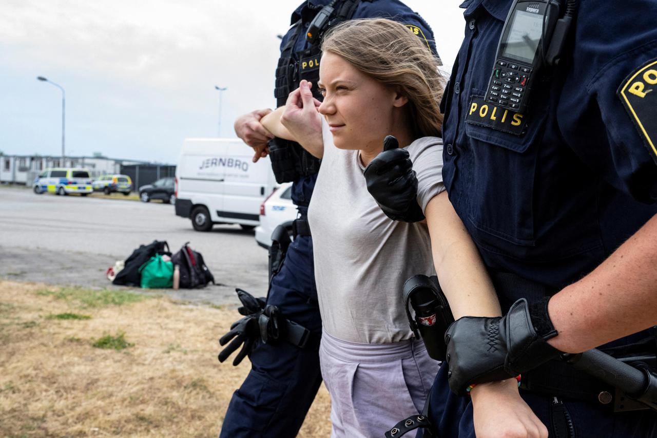 Police remove Greta Thunberg as they move climate activists who are blocking the entrance to Oljehamnen in Malmo