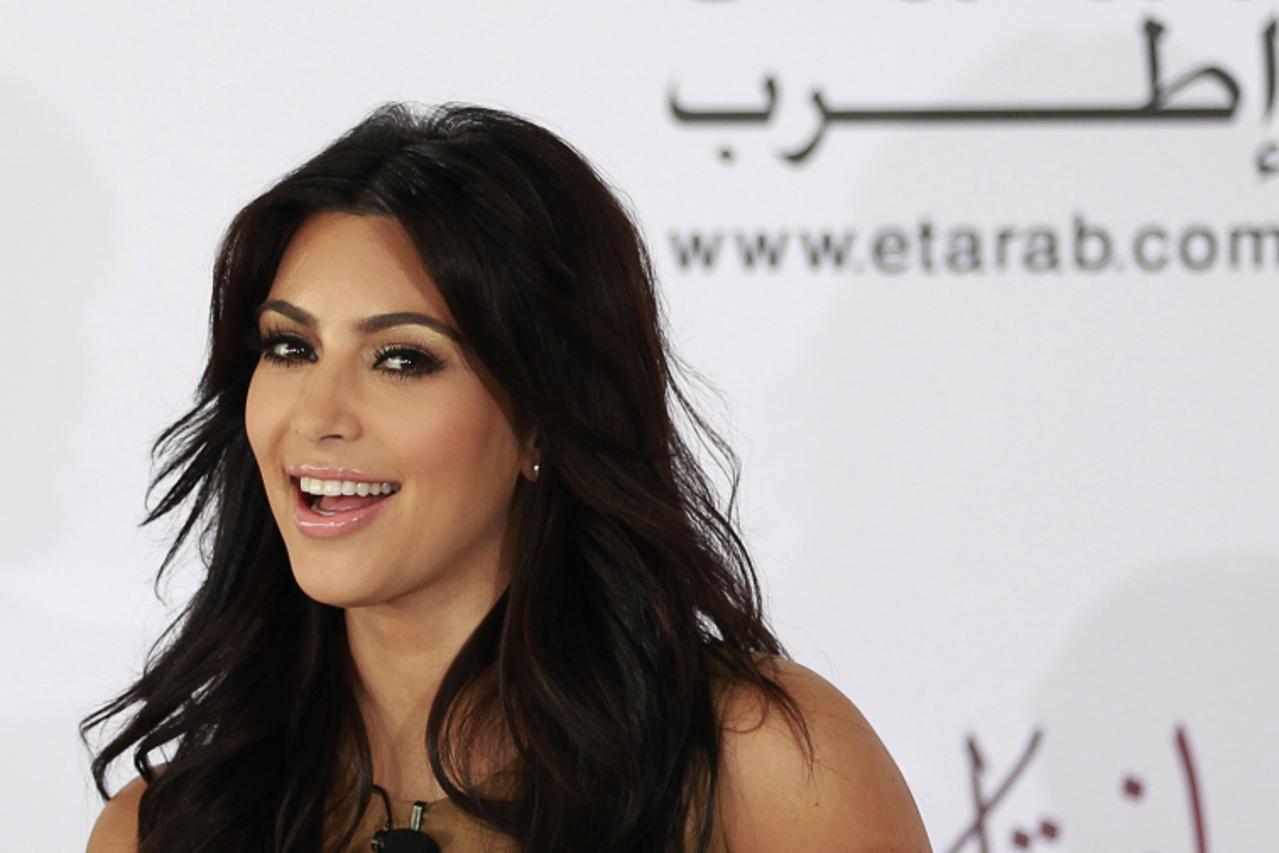 'TV personality Kim Kardashian smiles during a news conference in Dubai October 13, 2011. Kardashian is in the United Arab Emirates to launch the opening of a milkshake bar at the Dubai Mall on Octobe