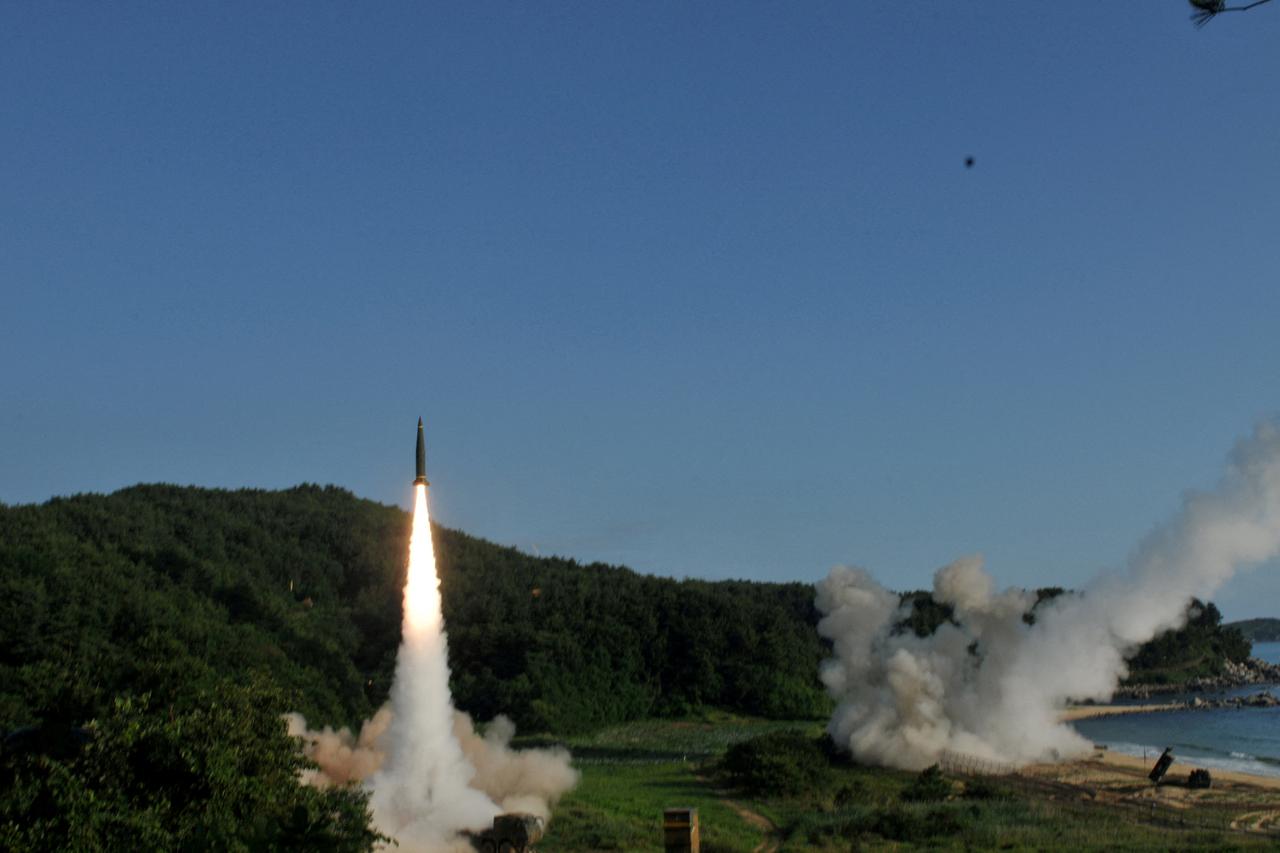 FILE PHOTO: Handout of United States and South Korean troops utilizing the Army Tactical Missile System (ATACMS) and South Korea's Hyunmoo Missile II, fire missiles into the waters of the East Sea, off South Korea