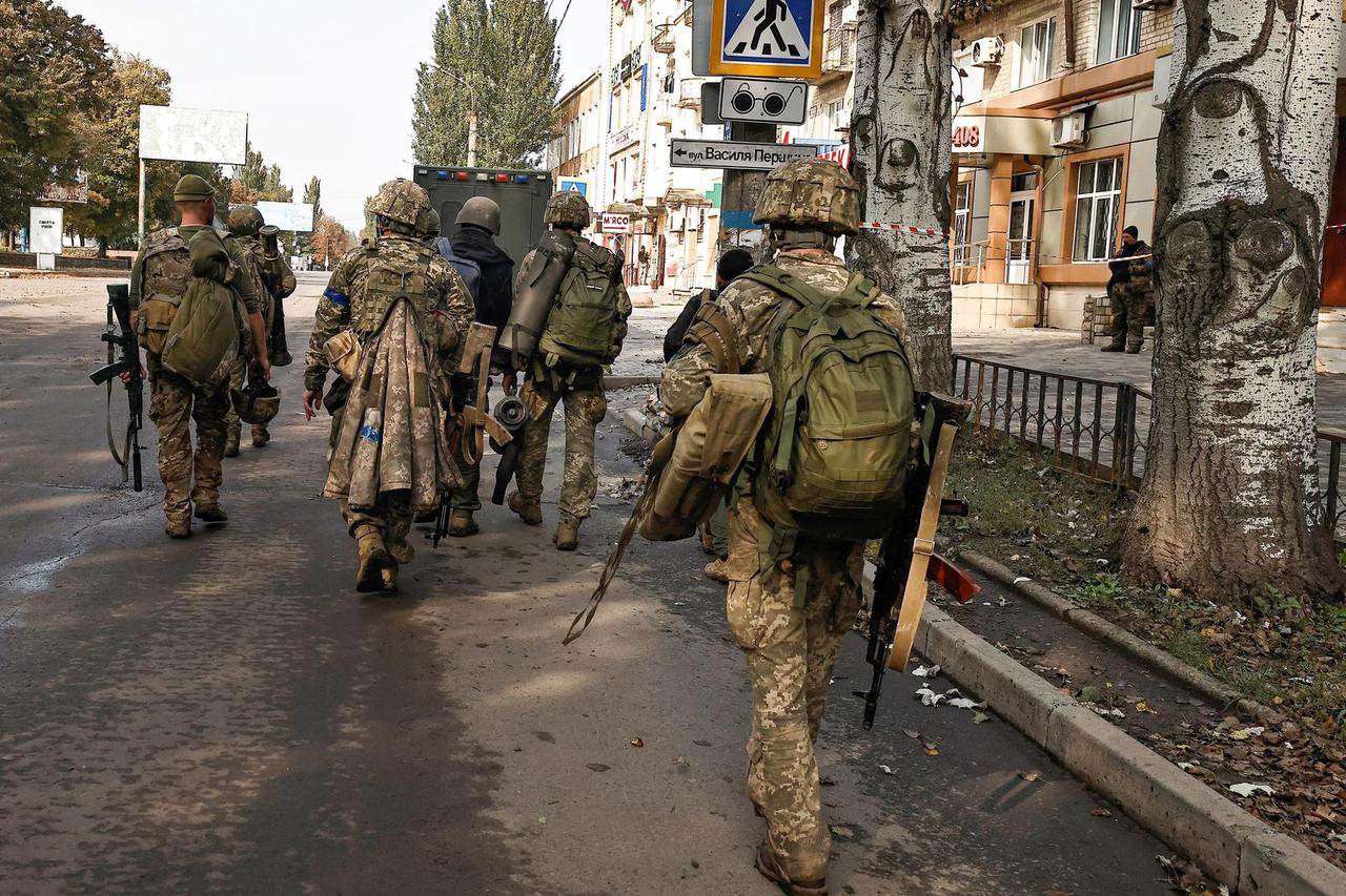 FILE PHOTO: Ukrainian soldiers walk in Bakhmut