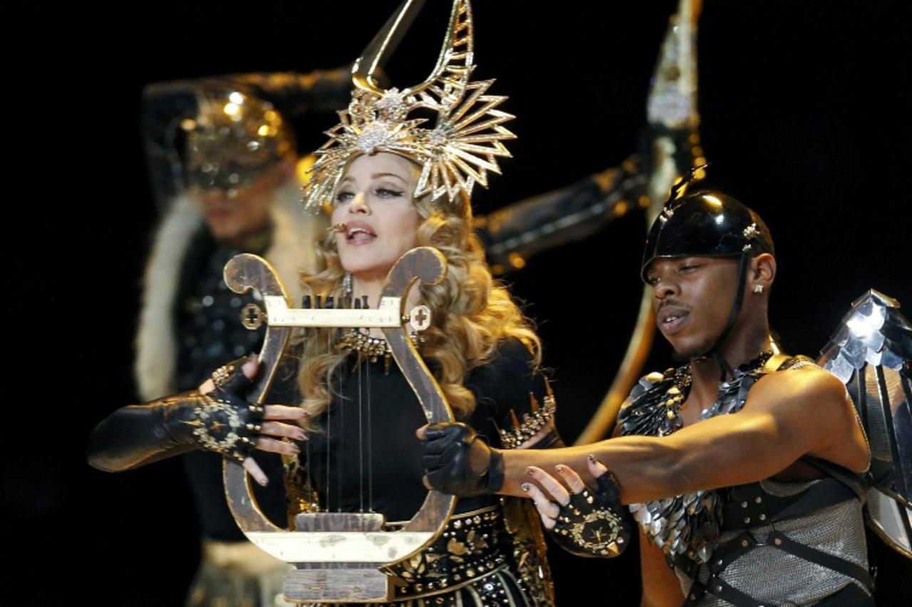 'Madonna performs during the halftime show in the NFL Super Bowl XLVI football game in Indianapolis, Indiana, February 5, 2012. REUTERS/Mike Segar (UNITED STATES  - Tags: SPORT FOOTBALL)'
