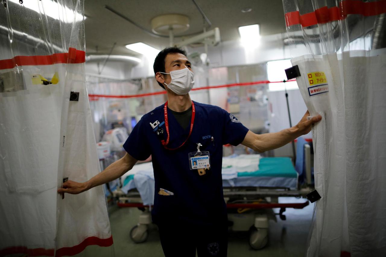 FILE PHOTO: Doctor draws curtain in critical care ward at Yokohama hospital