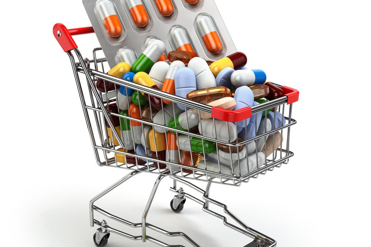 Pharmacy medicine concept. Shopping cart with pills and capsules. 3d
