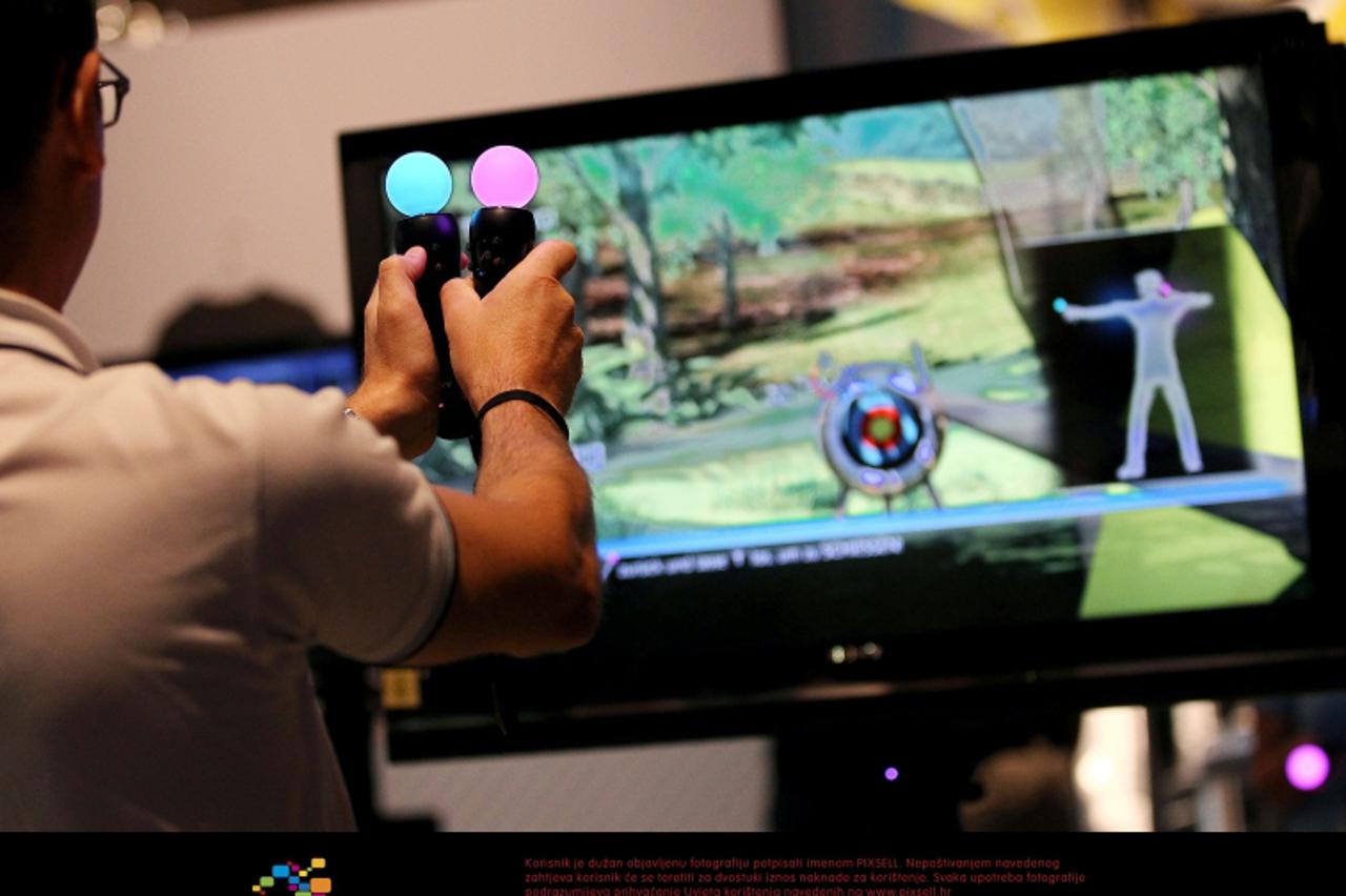 'A man tests a motion-controlled game \'Move\' with the  Playstation III at the booth of Sony during the fair \'Gamescom\' in Cologne, Germany, 18 August 2010. The computer game-fair \'Gamescom\' take