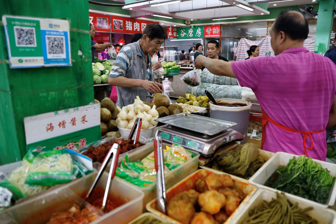 Pickle vendor attends to a customer at a morning market in Beijing