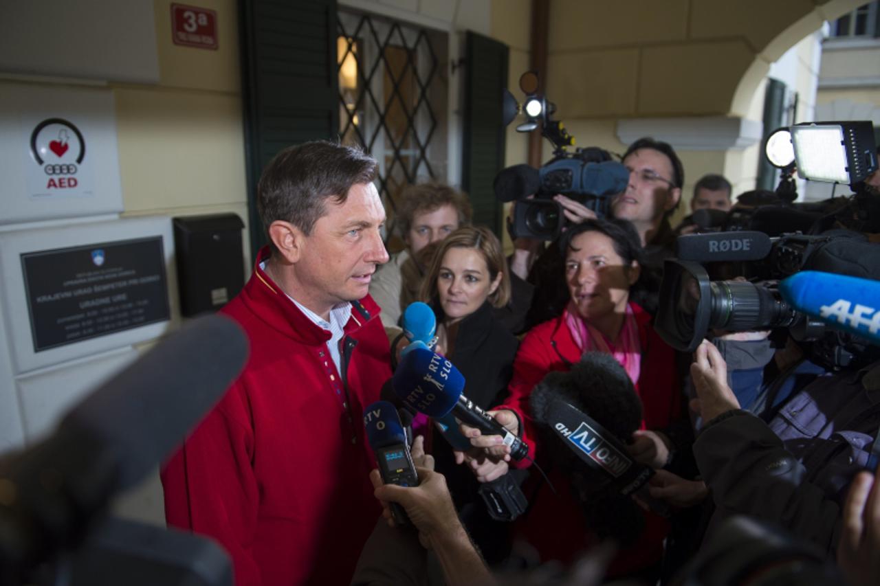 'Former Slovenian Prime Minister and presidential candidate Borut Pahor speaks to the press after voting at a polling station in Sempeter during the presidential elections on November 11, 2012. Sloven