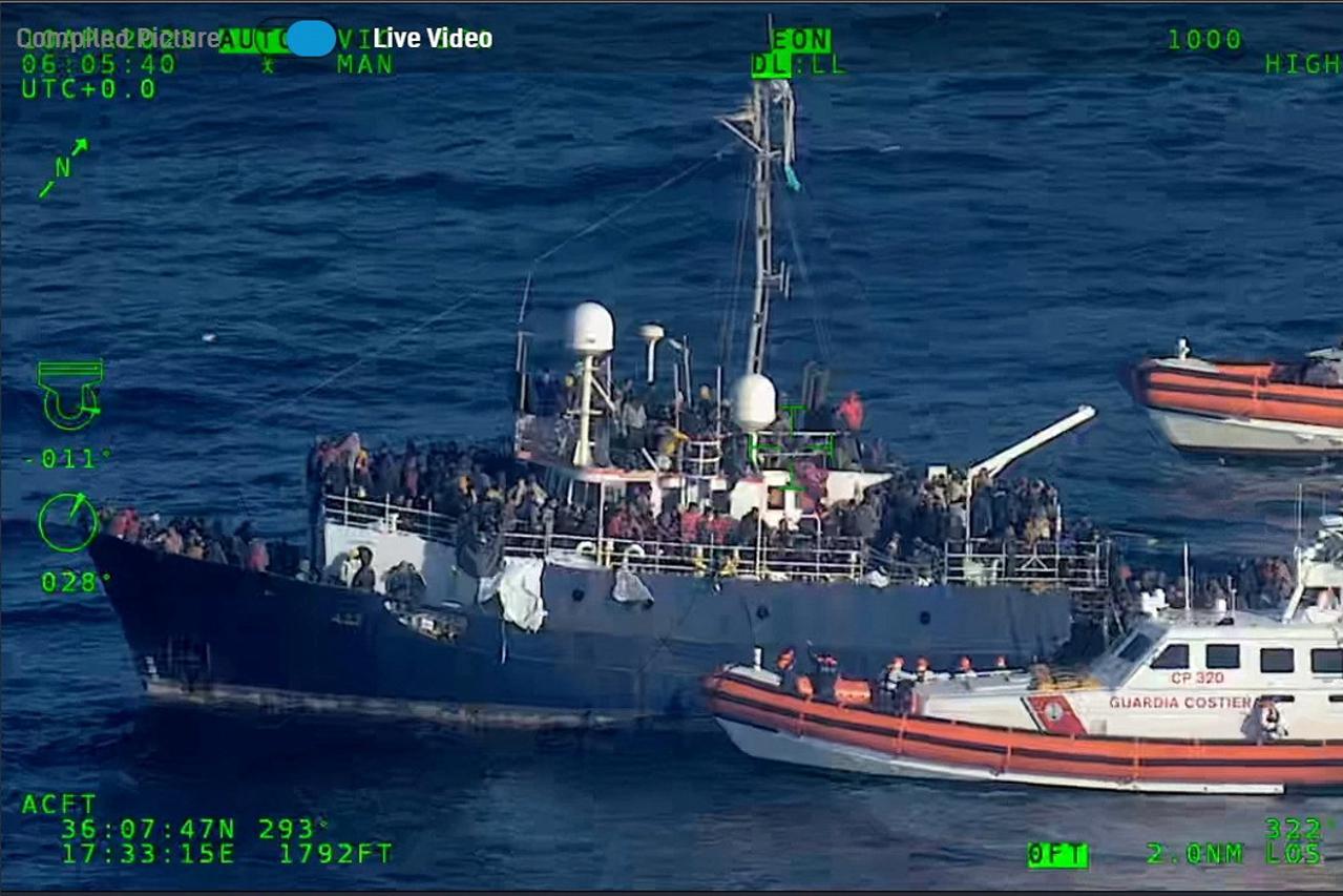 Migrants wait to be rescued by Italian Coast Guard off the coast of Italy