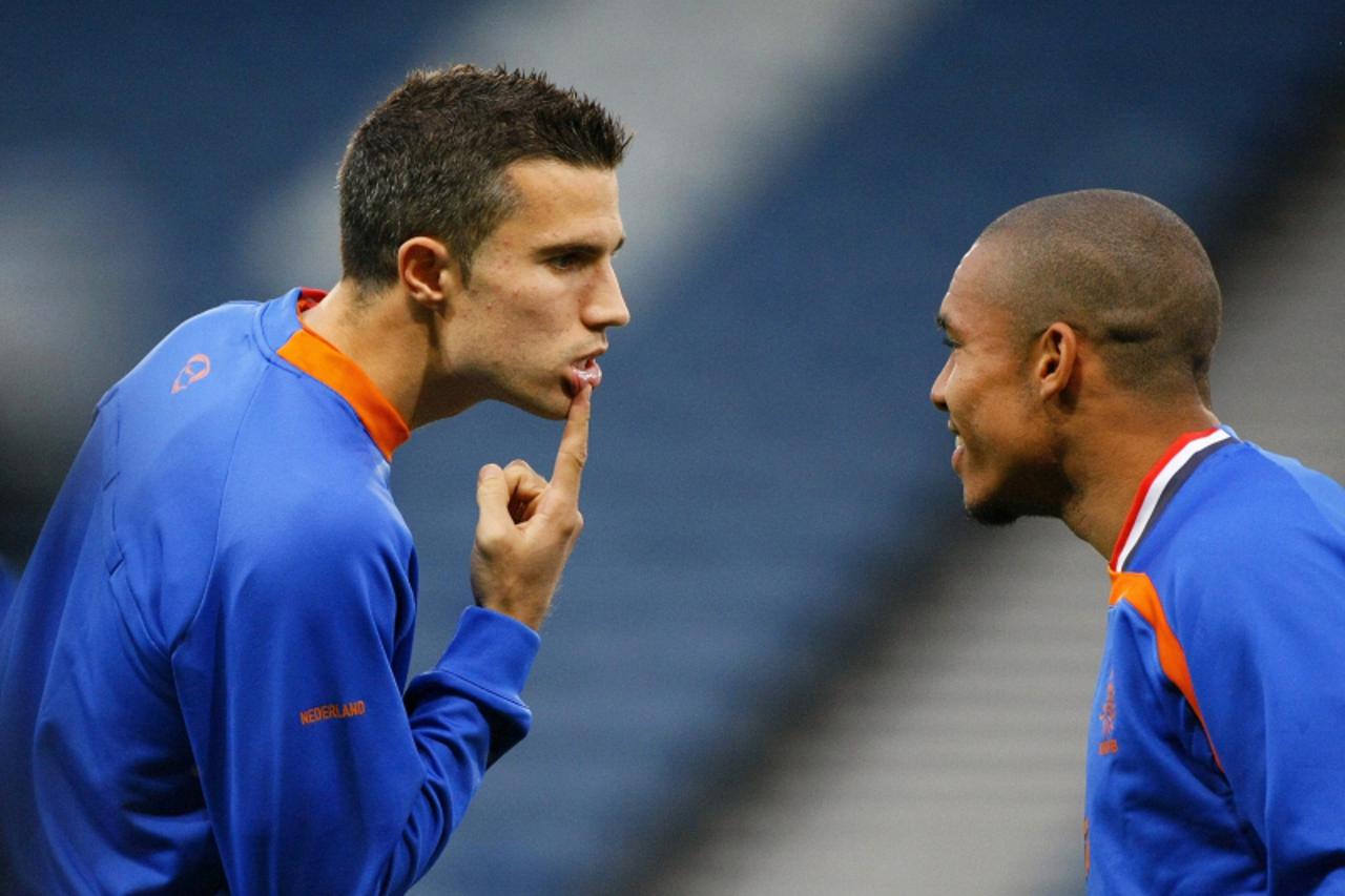 'REFILE - CHANGING NAME OF COUNTRY Robin van Persie of the Netherlands shows his lip to teammate Nigel De Jong during a training session at Hampden Park stadium in Glasgow, Scotland ahead of their Wor