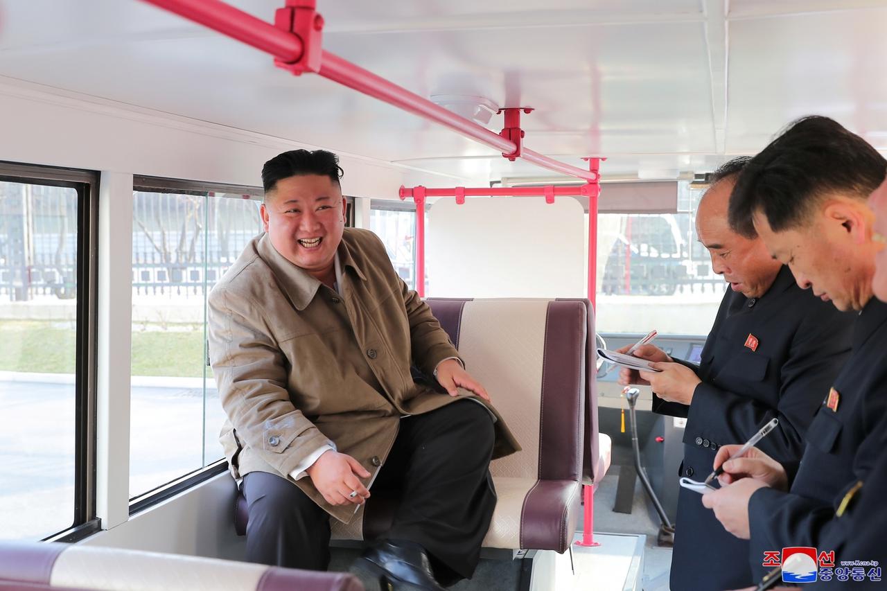 North Korean leader Kim Jong-un sits inside a trial version of a double-decker bus in Pyongyang