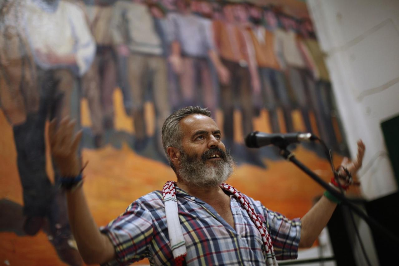 'Marinaleda's Mayor and Izquierda Unida (IU) Parliamentarian Juan Manuel Sanchez Gordillo, 59, gestures as he speaks during a popular assembly in Marinaleda, southern Spain, August 15, 2012. Gordillo