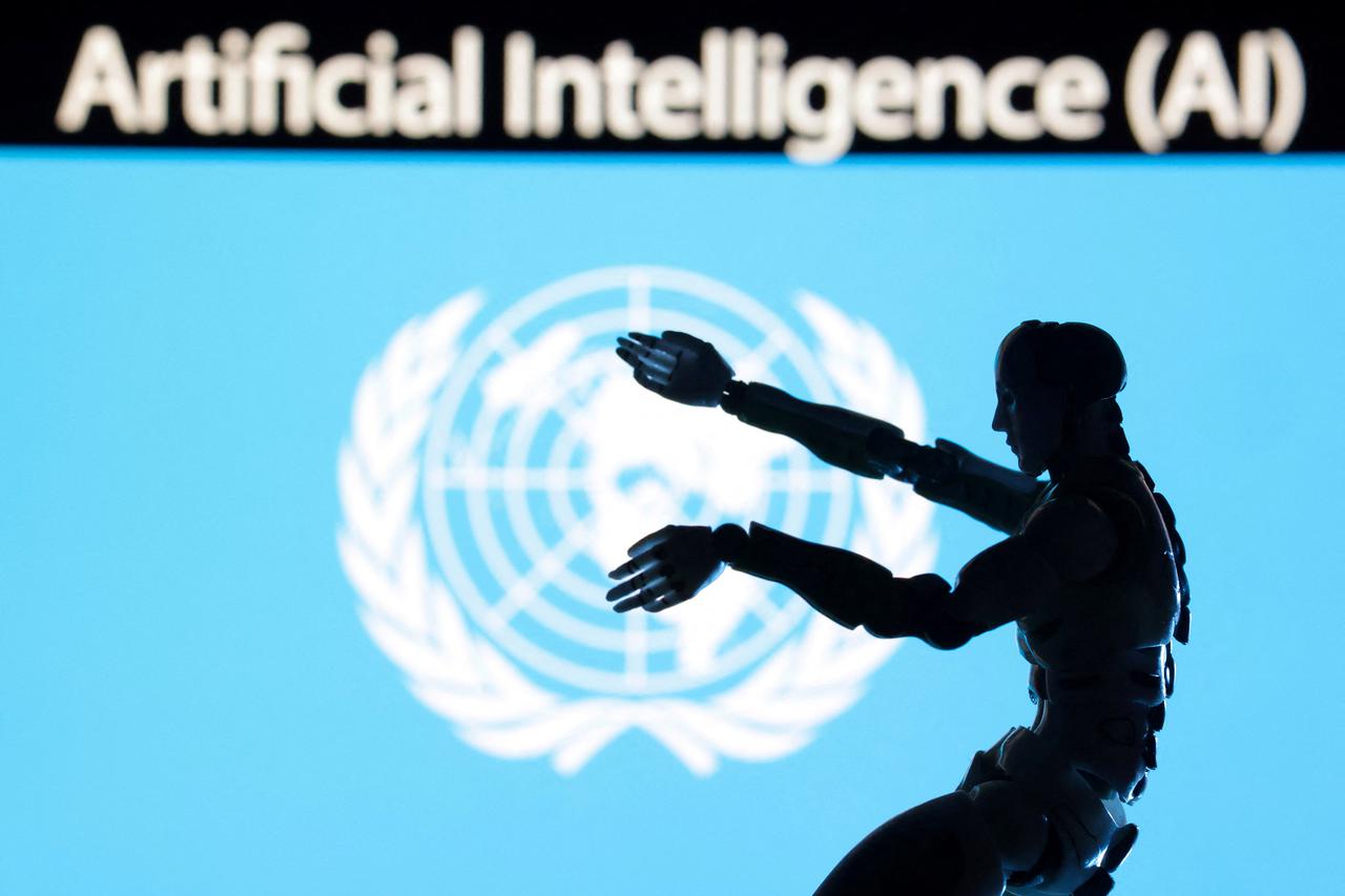 AI Artificial intelligence words, miniature of robot and UN flag are seen in this illustration taken December 21, 2023.