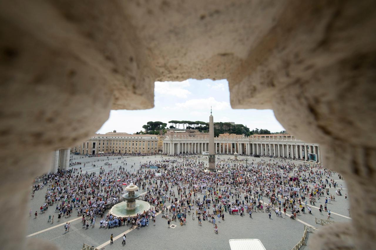 People stand at St Peter's Square as Pope Francis delivers the Angelus hours before being admitted to Gemelli hospital for colon surgery, at the Vatican
