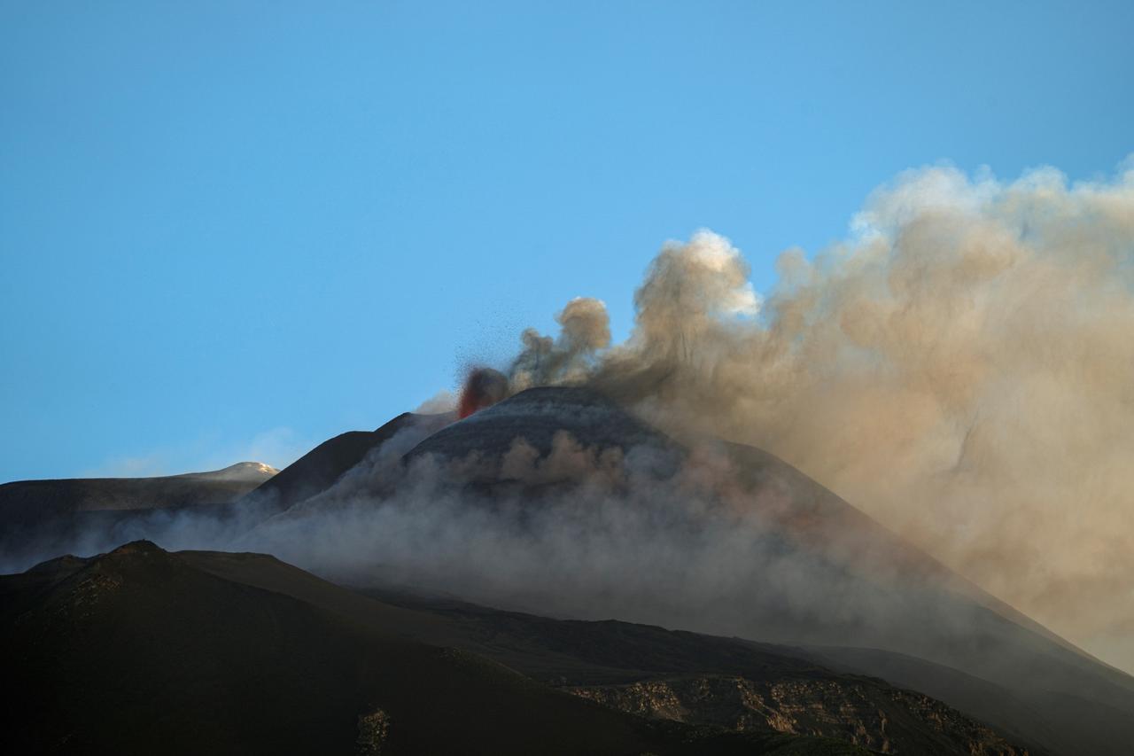 Mount Etna lights up the early morning sky