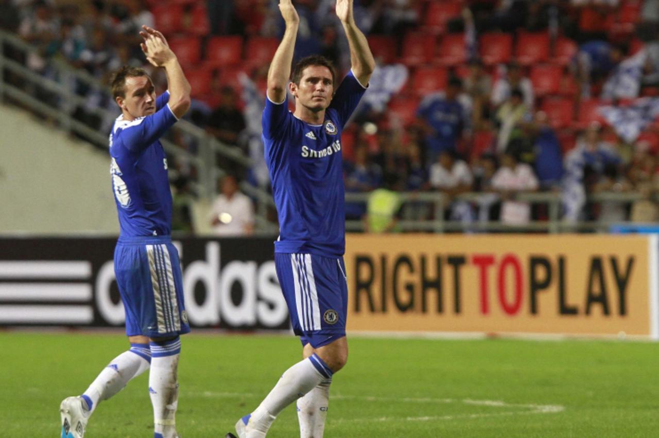'English Premier League Chelsea\'s John Terry (L) and Frank Lampard wave to fans after their friendly soccer match against Thailand Premier League All Stars at the Rajamangala national stadium in Bang