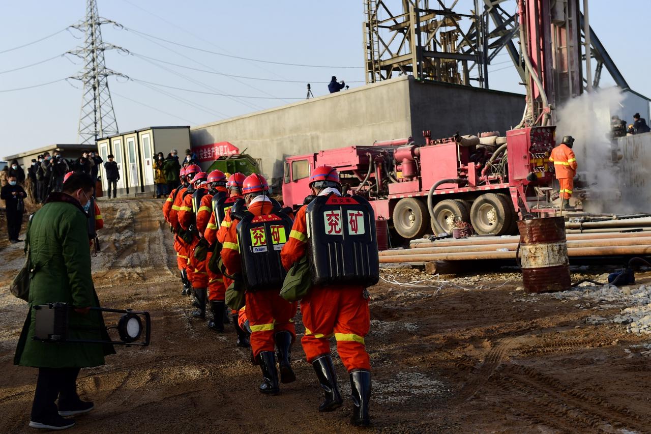 Rescuers are seen at the site where workers were trapped underground after an explosion at the gold mine under construction, in Qixia