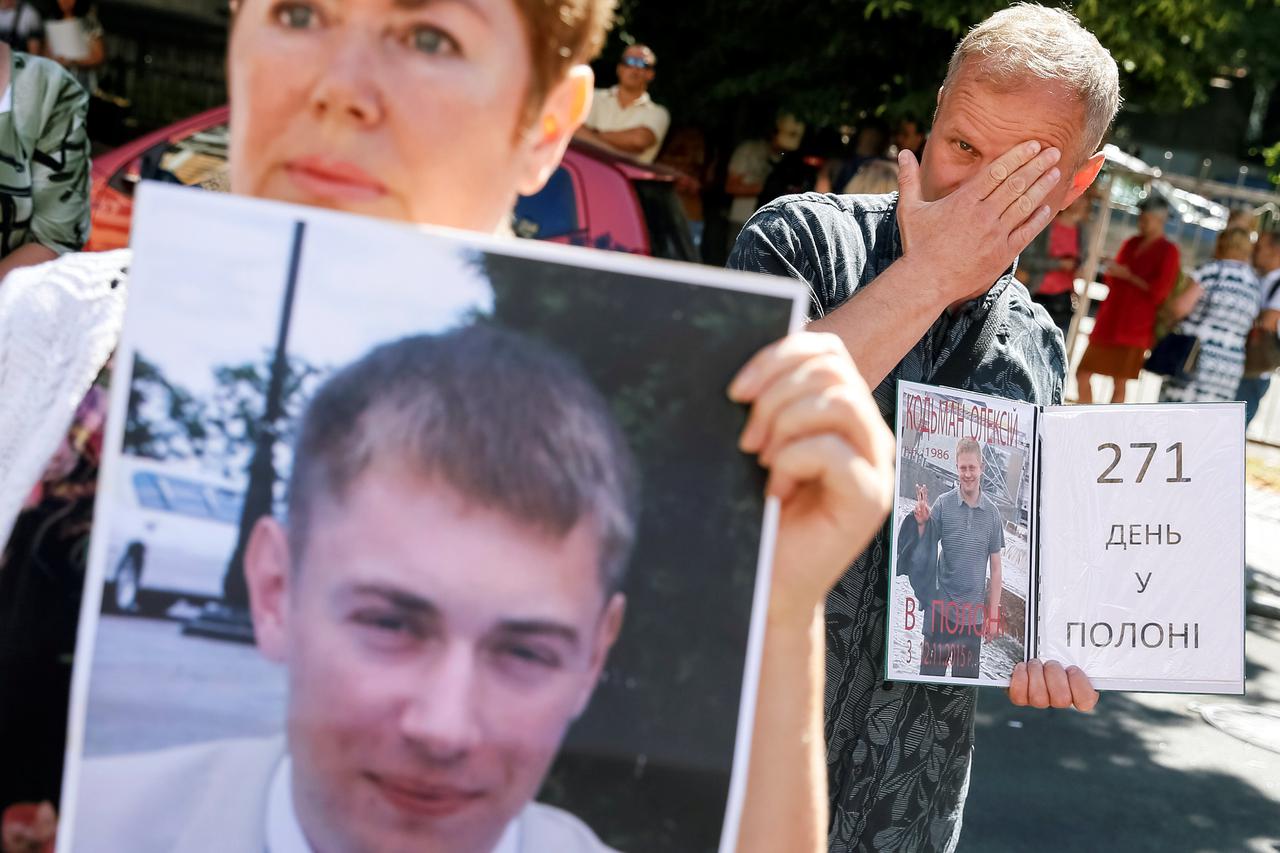 Relatives of Ukrainian prisoners of war hold up portraits of their loved ones as they take part in a rally near the presidential administration to urge the authorities to speed up their release in Kiev Relatives of Ukrainian prisoners of war, hold up port