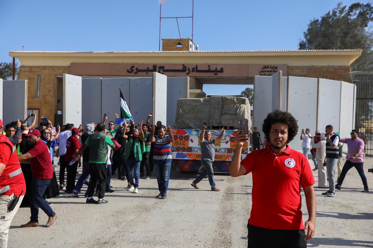 Trucks carrying humanitarian aid from Egyptian NGOs drive through the Rafah crossing from the Egyptian side in Rafah