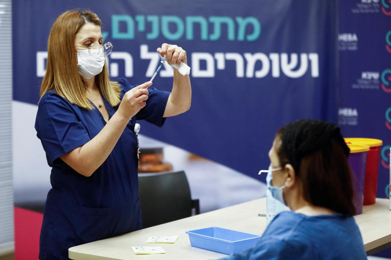 People receive a fourth dose of coronavirus disease (COVID-19) vaccine after Israel's Health Ministry approved a second booster for the immunocompromised, in Ramat Gan