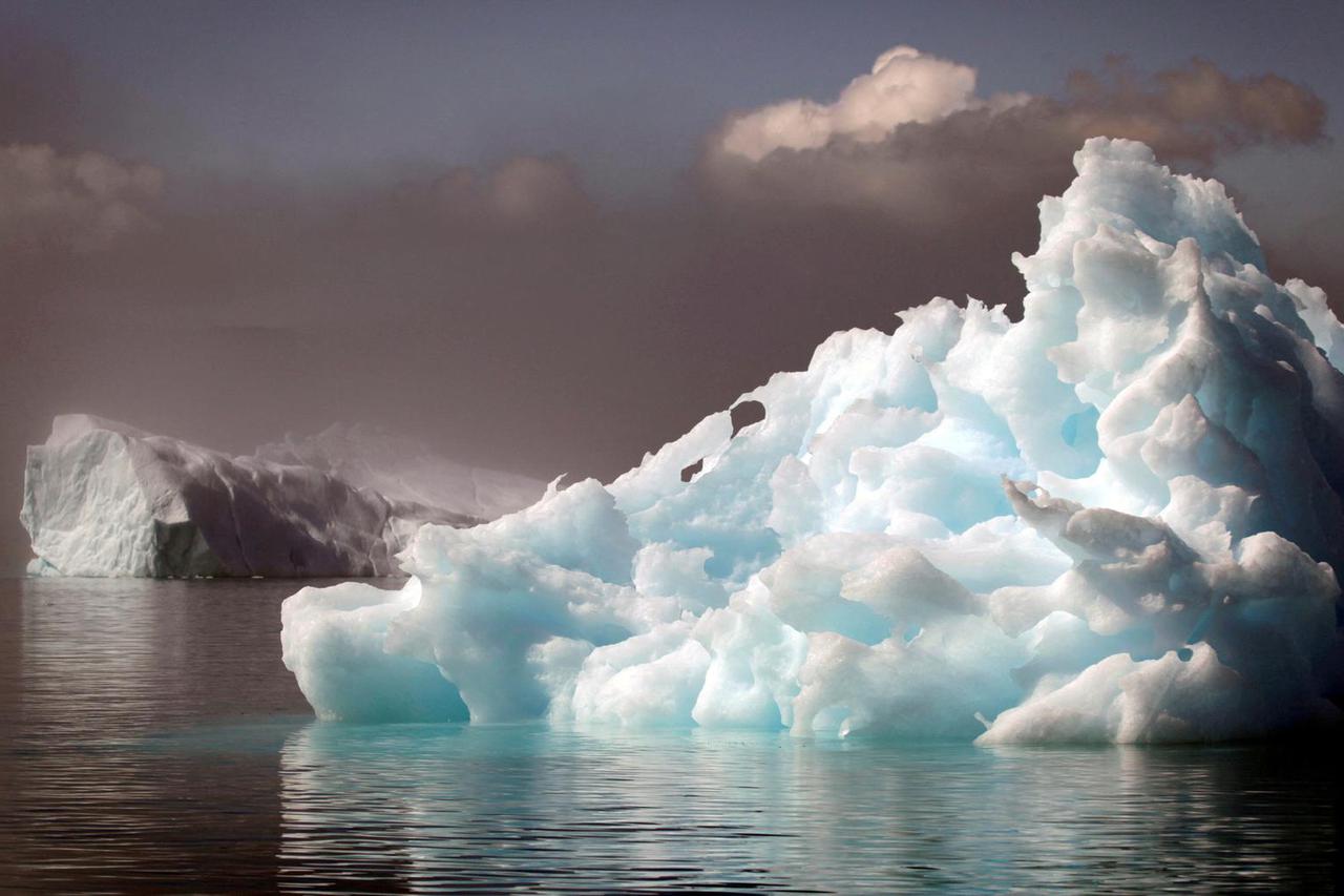 FILE PHOTO: Icebergs float in a fjord near the south Greenland town of Narsaq