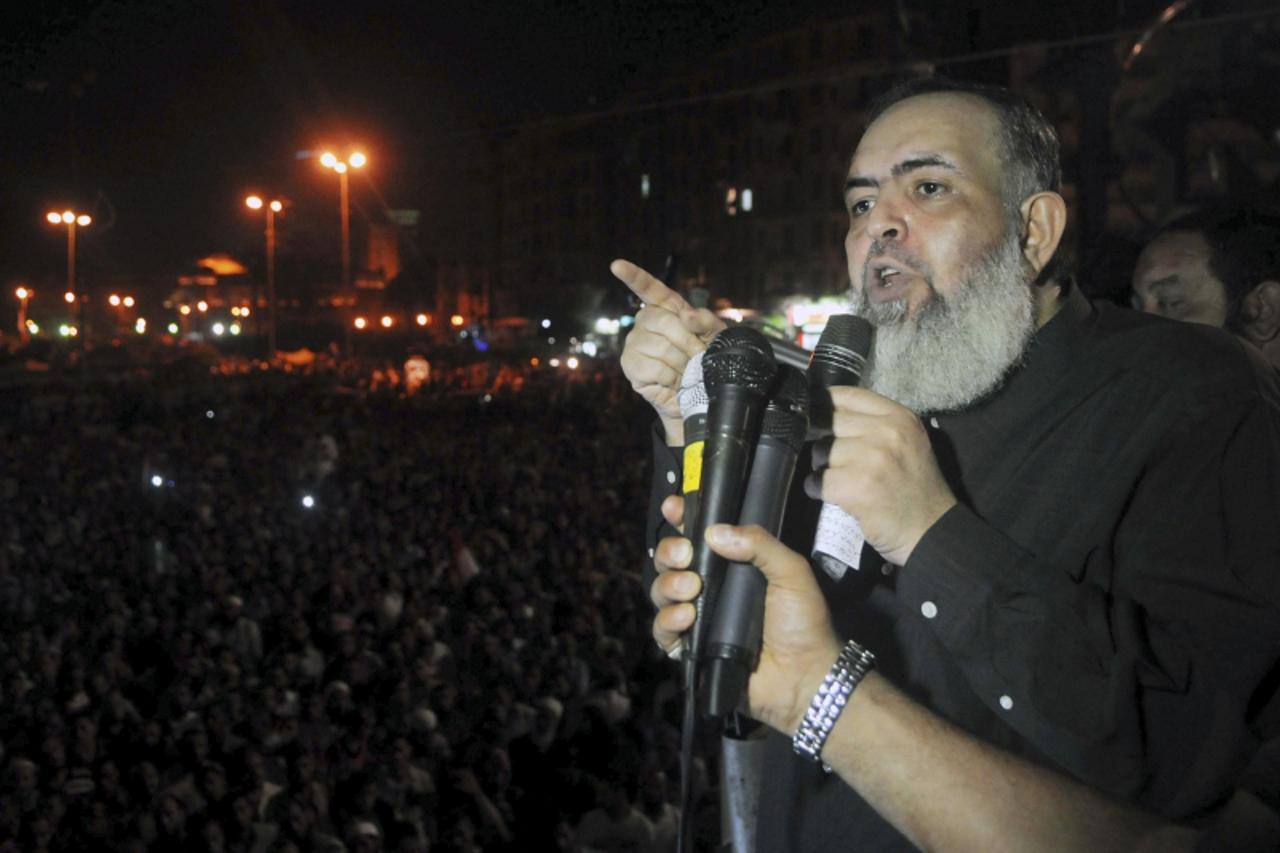 'Egypt's Salafi leader and former presidential candidate Hazem Salah Abu Ismail speaks to his supporters and supporters of Islamist President Mohamed Mursi at Tahrir Square in Cairo July 13, 2012. Ab