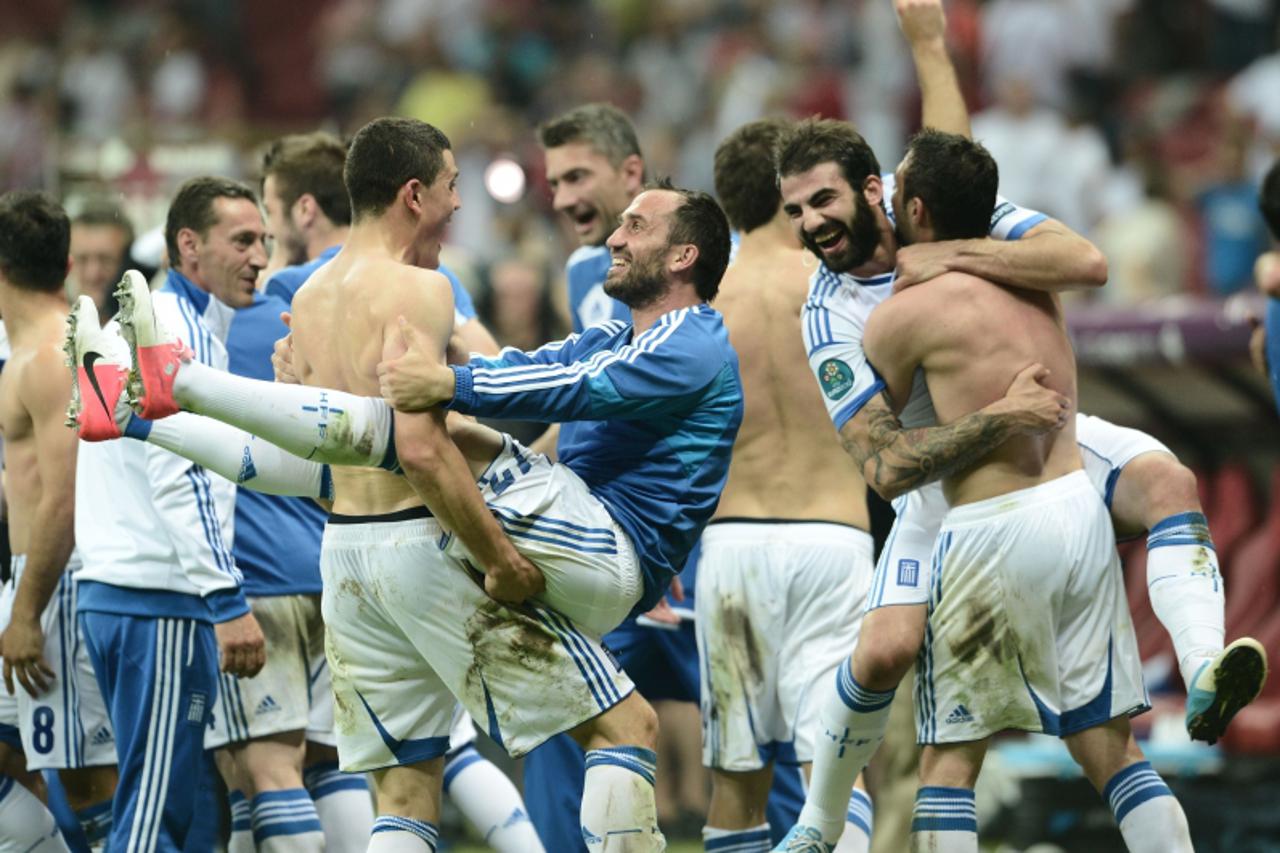 'Greek players celebrate after the Euro 2012 championships football match Greece vs Russia on June 16, 2012 at the National Stadium in Warsaw.    AFP PHOTO / ARIS MESSINIS '