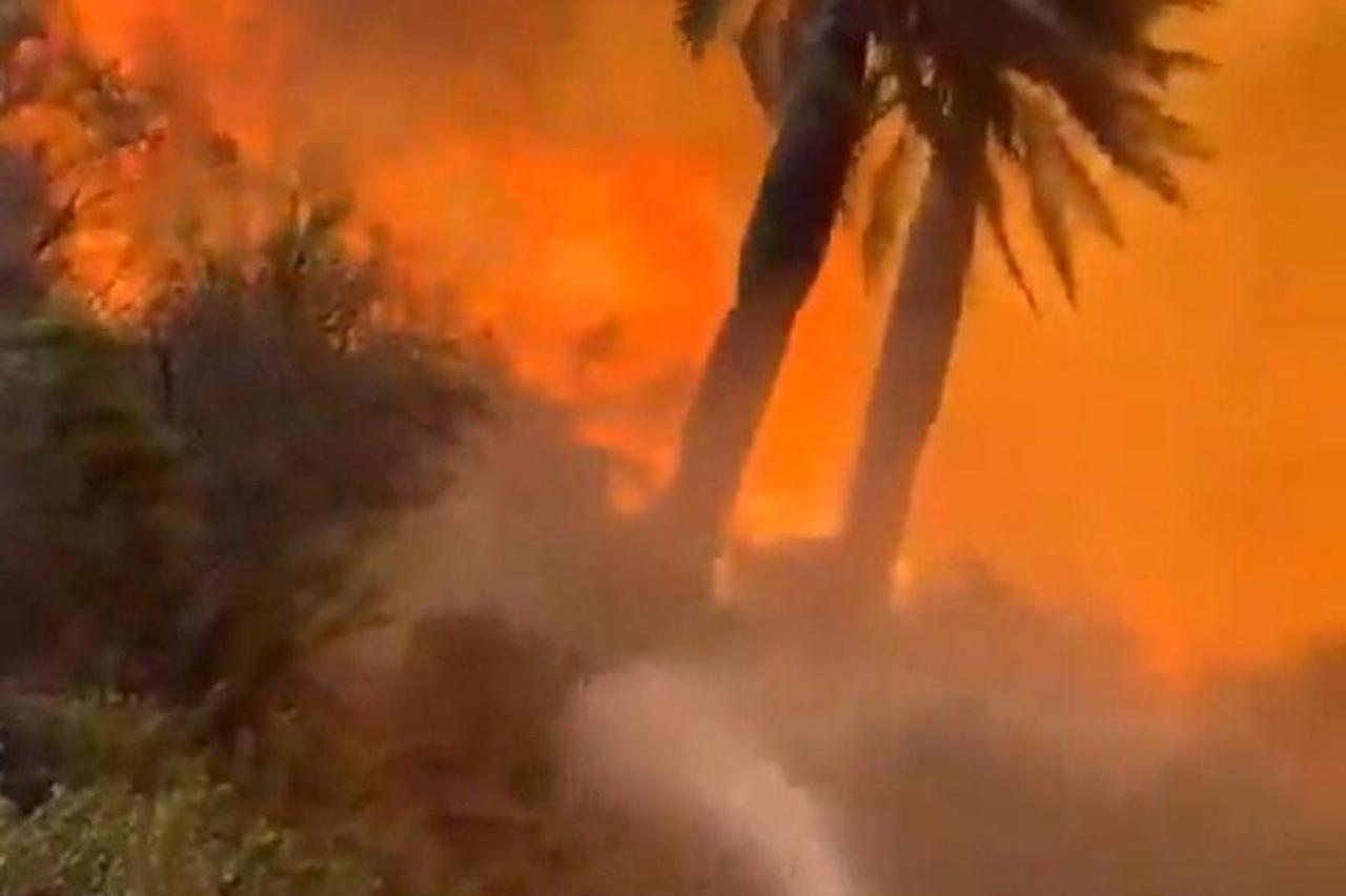 A house burns amid the spread of wildfires in Vina del Mar
