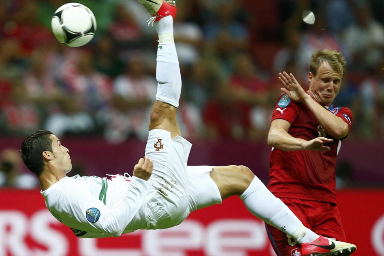 'Portugal\'s Cristiano Ronaldo kicks the ball in front of Czech Republic\'s Michal Kadlec (R) during their Euro 2012 quarter-final soccer match at the National stadium in Warsaw June 21, 2012. Picture