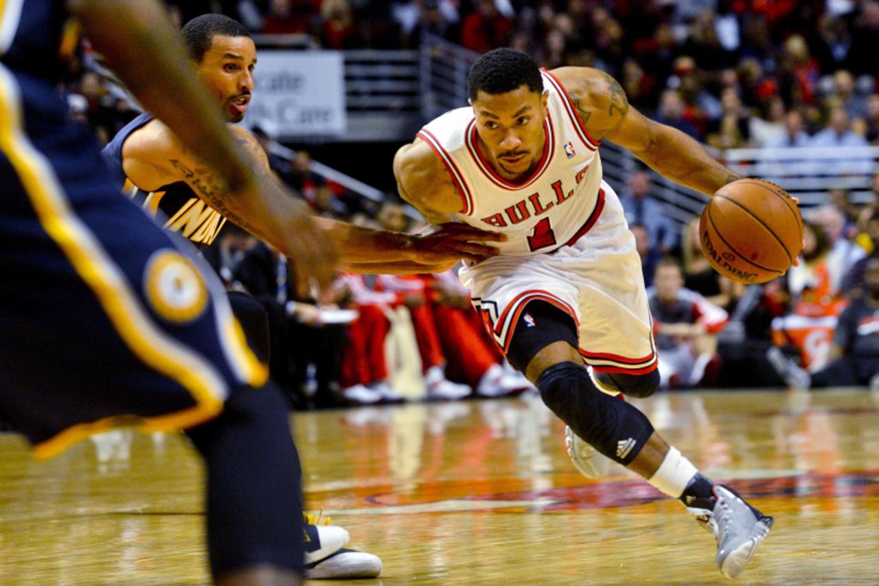 'Oct 18, 2013; Chicago, IL, USA; Chicago Bulls guard Derrick Rose dribbles against the Indiana Pacers guard George Hill at the United Center. Mandatory Credit: Matt Marton-USA TODAY Sports'