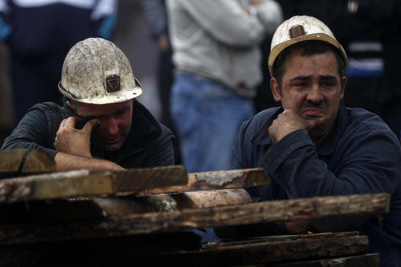 Coal miners cries in front of the Raspotocje coal mine in Zenica, September 5, 2014. Thirty-four Bosnian coal miners were trapped half a kilometre underground on Friday after an earthquake triggered a rock burst, leaving rescue teams struggling to clear d
