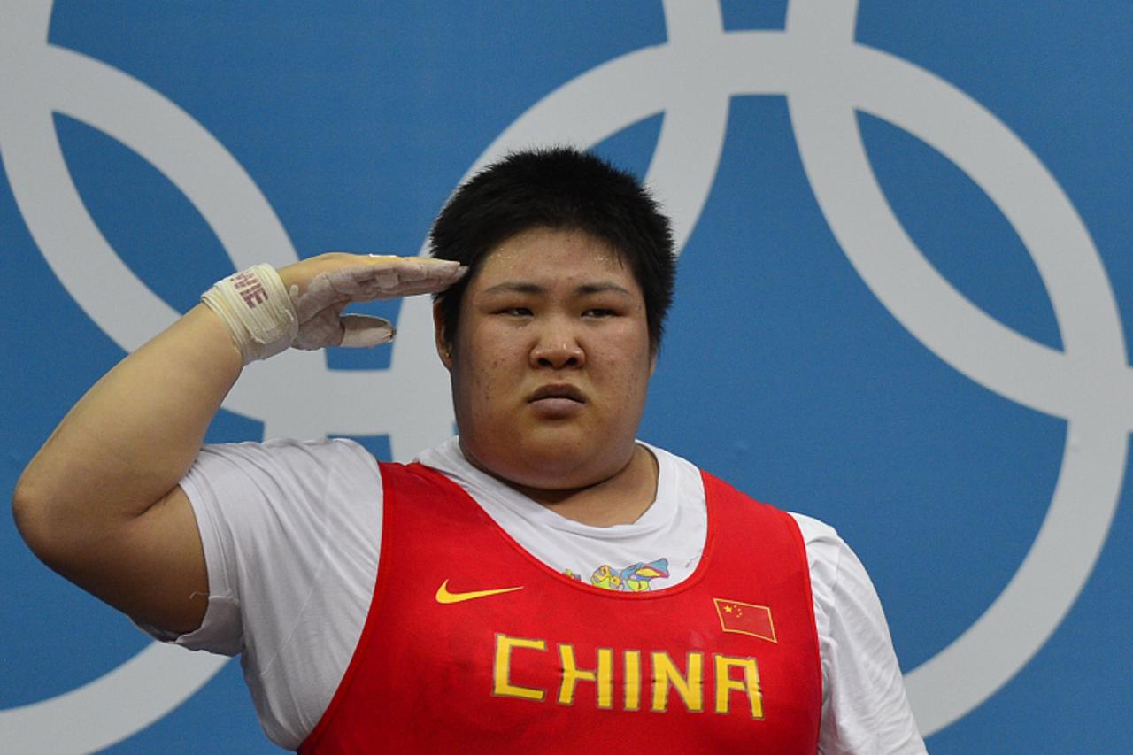 'Goild medallist China\'s Zhou Lulu salutes during the women\'s 75+kg group A weightlifting event of the London 2012 Olympic Games at The Excel Centre in London on August 5, 2012. AFP PHOTO / YURI COR