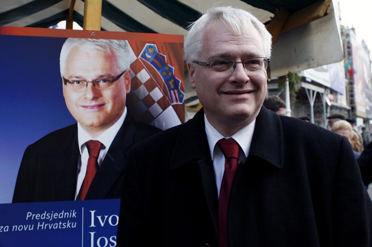 'Presidential candidate of Croatia\'s Social Democrats, Ivo Josipovic, smiles in front of his poster at the beginning of campaign at Zagreb\'s main square on November 5, 2009. Croatia holds their pres