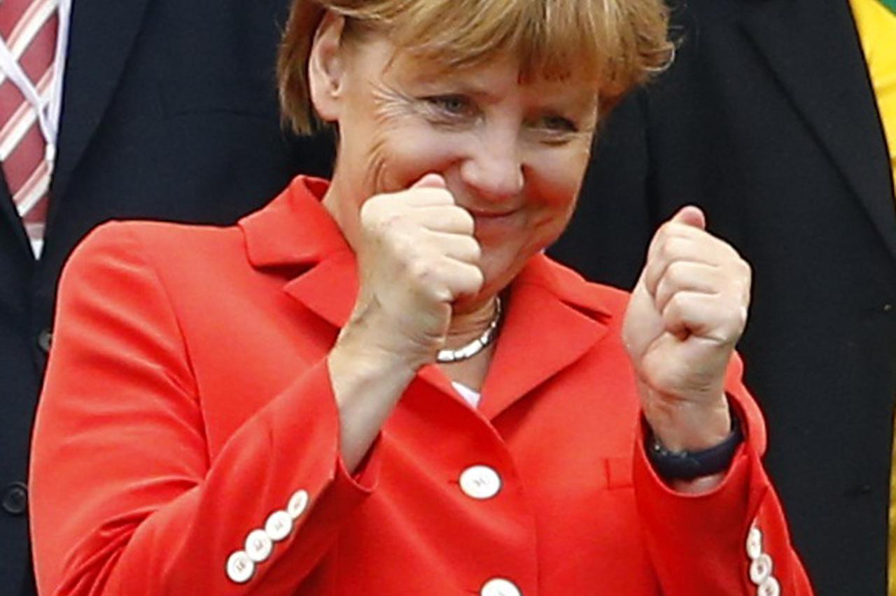 German Chancellor Angela Merkel gestures before their 2014 World Cup Group G soccer match against Portugal at the Fonte Nova arena in Salvador in this June 16, 2014, file photo. REUTERS/Darren Staples/Files (BRAZIL  - Tags: SOCCER SPORT WORLD CUP)   ATTEN