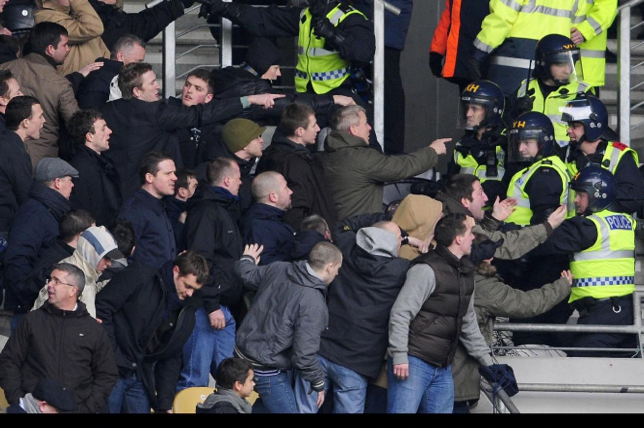 'Soccer - FA Cup - Fourth Round - Hull City v Millwall - KC Stadium Riot police control Milwall fans during the FA Cup, Fourth Round at the KC Stadium, Hull.'