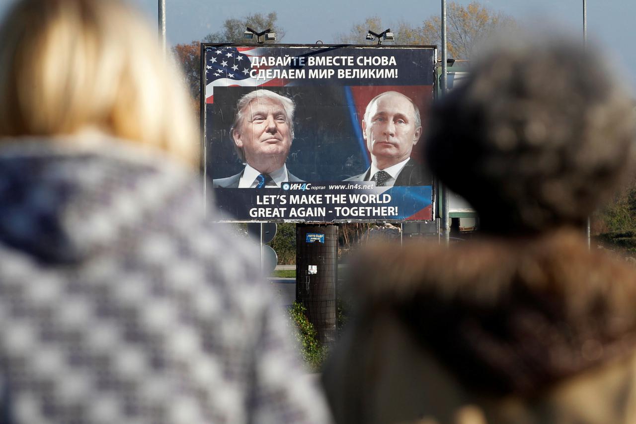 FILE PHOTO: A billboard showing a pictures of US president-elect Donald Trump and Russian President Vladimir Putin is seen through pedestrians in Danilovgrad, Montenegro, November 16, 2016. REUTERS/Stevo Vasiljevic/File photo     TPX IMAGES OF THE DAY