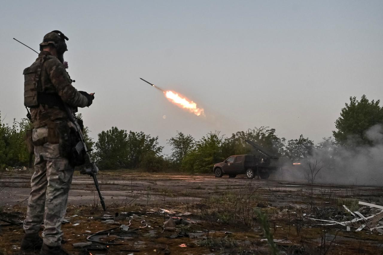 Members of company tactical group "Steppe Wolves" fire a handmade small multiple rocket launch system toward Russian troops in Zaporizhzhia region
