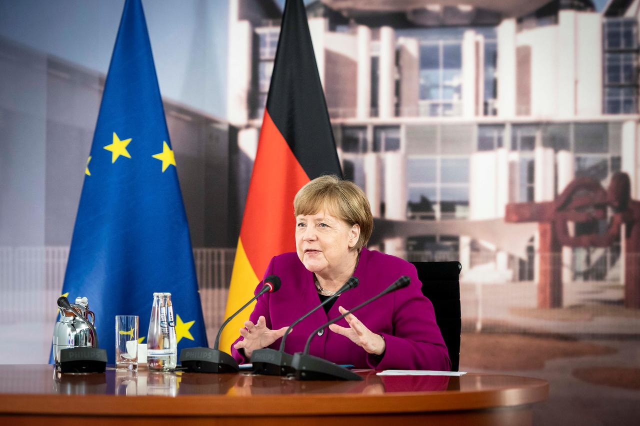 A handout picture shows German Chancellor Angela Merkel talking to French President Emmanuel Macron during a joint video conference in the chancellery in Berlin