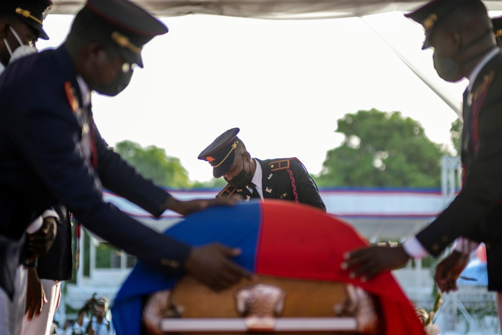 Haiti holds funeral for assassinated President Jovenel Moise in Cap-Haitien Presidential honor guards place a national flag over the coffin of late Haitian President Jovenel Moise, who was shot dead earlier this month, during the funeral at his family home in Cap-Haitien, Haiti, July 23, 2021. REUTERS/Ricardo Arduengo RICARDO ARDUENGO