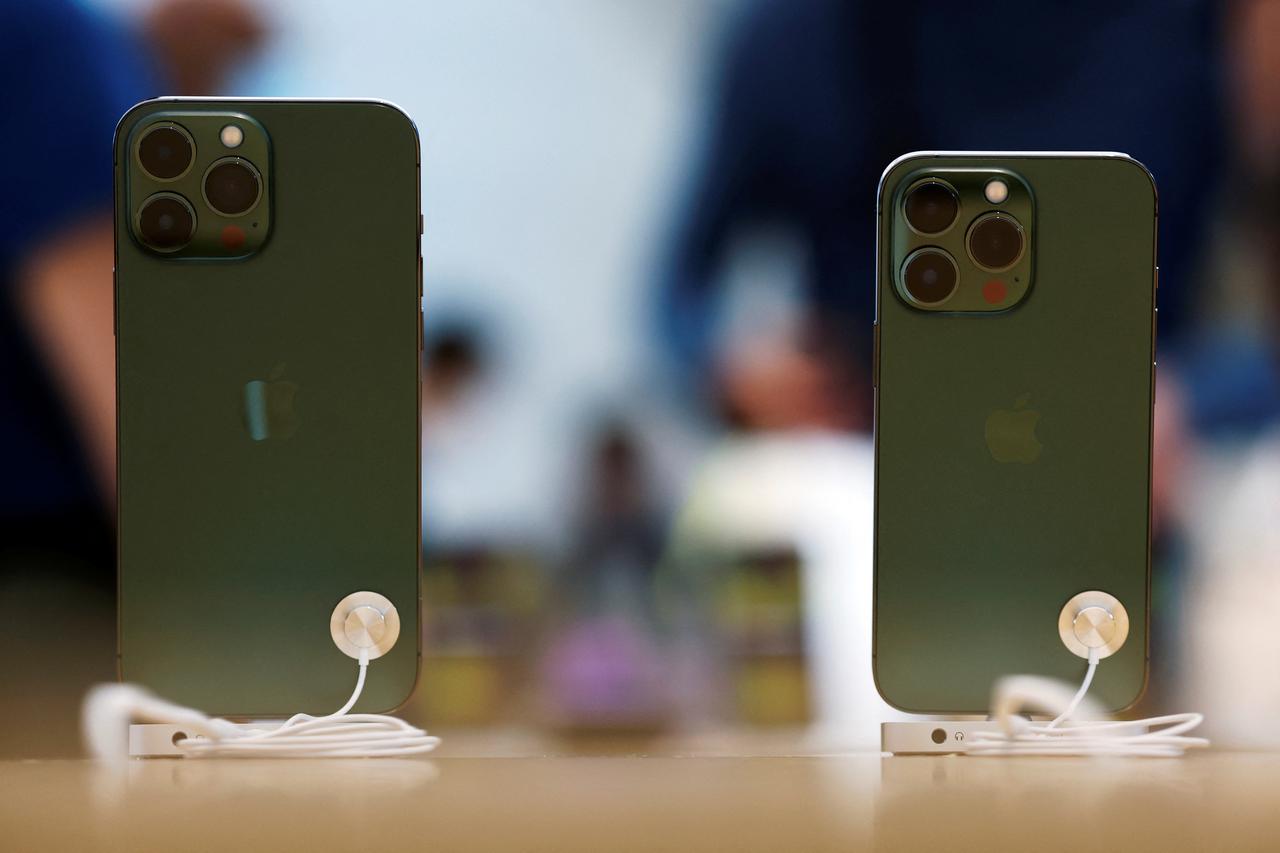 Apple iPhone 13 Pro models in the colour "alpine green" are displayed at an Apple shop in Singapore