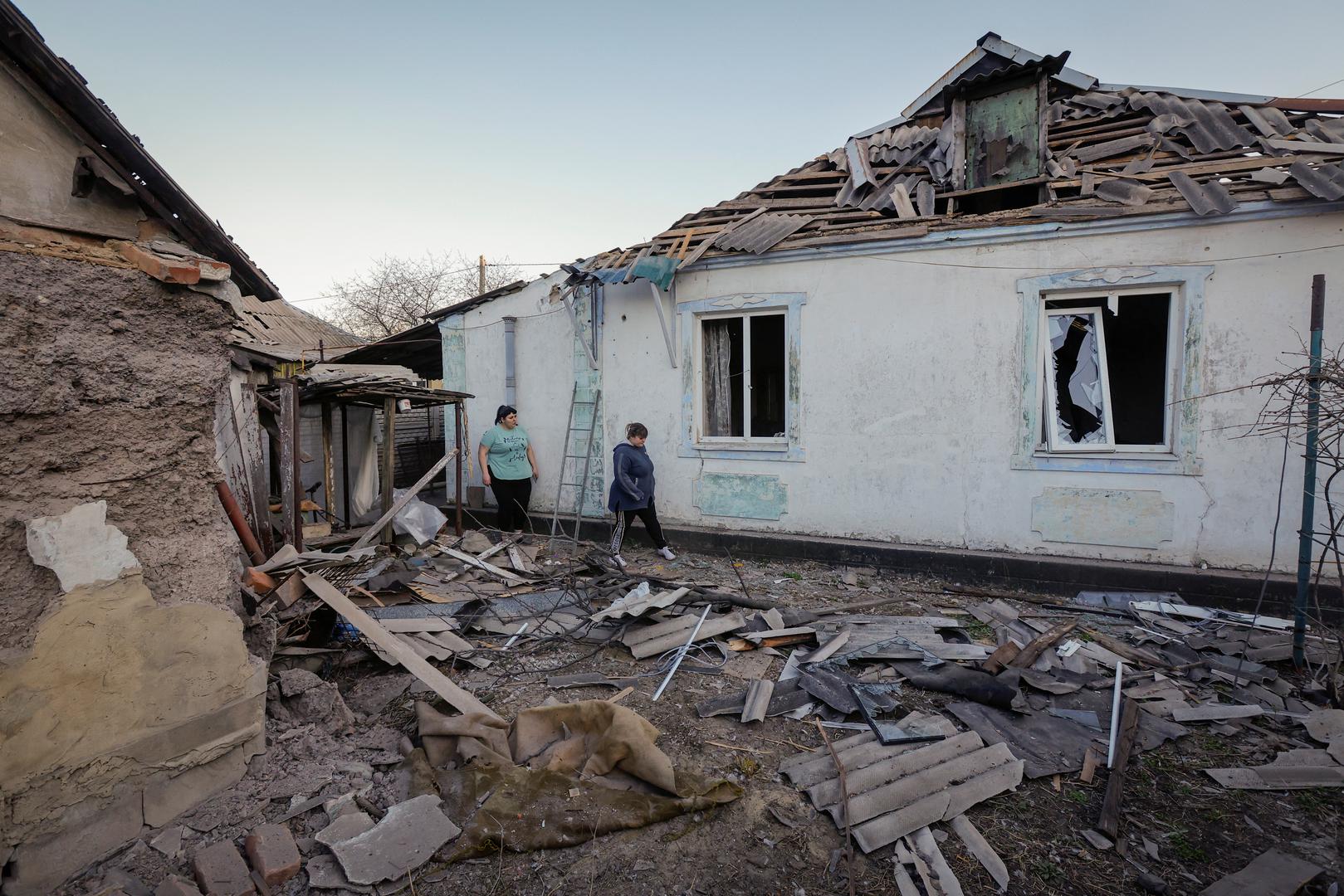 Sisters Ekaterina and Tatyana Nikonorova walk next to their house, which was damaged during a recent shelling in the course of the Russia-Ukraine conflict, in Donetsk, Russian-controlled Ukraine, April 6, 2024. REUTERS/Alexander Ermochenko Photo: Alexander Ermochenko/REUTERS