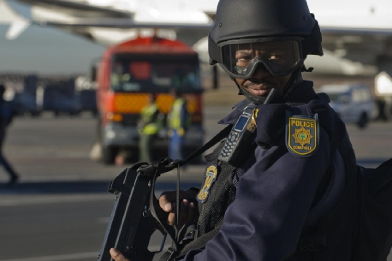 'A South African special forces policeman stands guard as the Mexican national football team arrives at te O.R Tambo airport in Johannesburg on June 5, 2010. Mexico will  have their first game on June