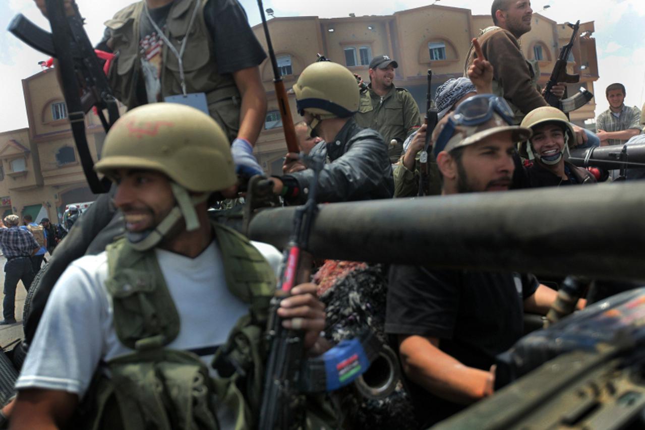 \'Libyan rebels patrol a street near the airport of Misrata on May 11, 2011 as they celebrate after capturing the city\'s strategic airport following a fierce battle with Moamer Kadhafi\'s troops, mar